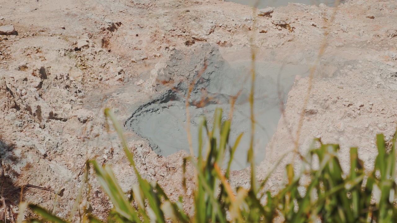 Close-up of a bubbling mud pit at Saint Lucia's Sulphur Springs, where volcanic activity churns beneath the earth in the world's only drive-in volcano.
