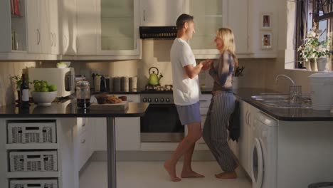 couple dancing in their kitchen