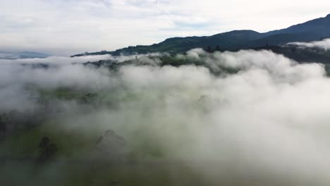 cinematic aerial drone clip over the misty mountaintop and clouds of the neblina area in machachi, equador