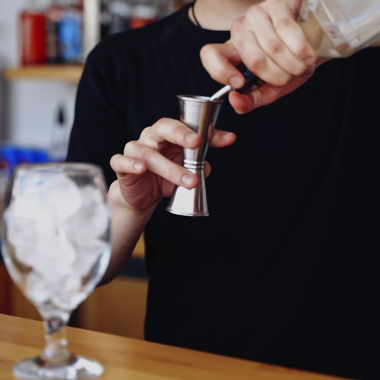 Expert barman making cocktail