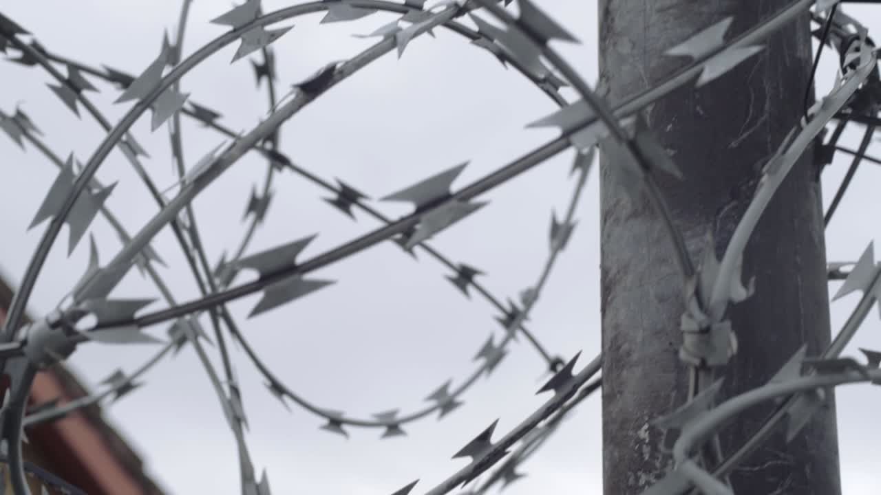 Razor wire protecting building on metal post