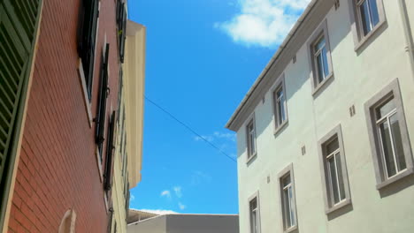 street view of colorful facades and windows under a clear blue sky in gibraltar, capturing the charm of mediterranean architecture