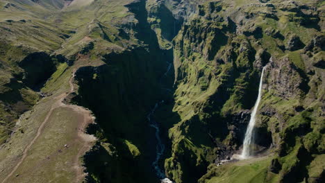 aerial drone above mulagljúfur canyon, sunny day with shadows, green and rocky 04