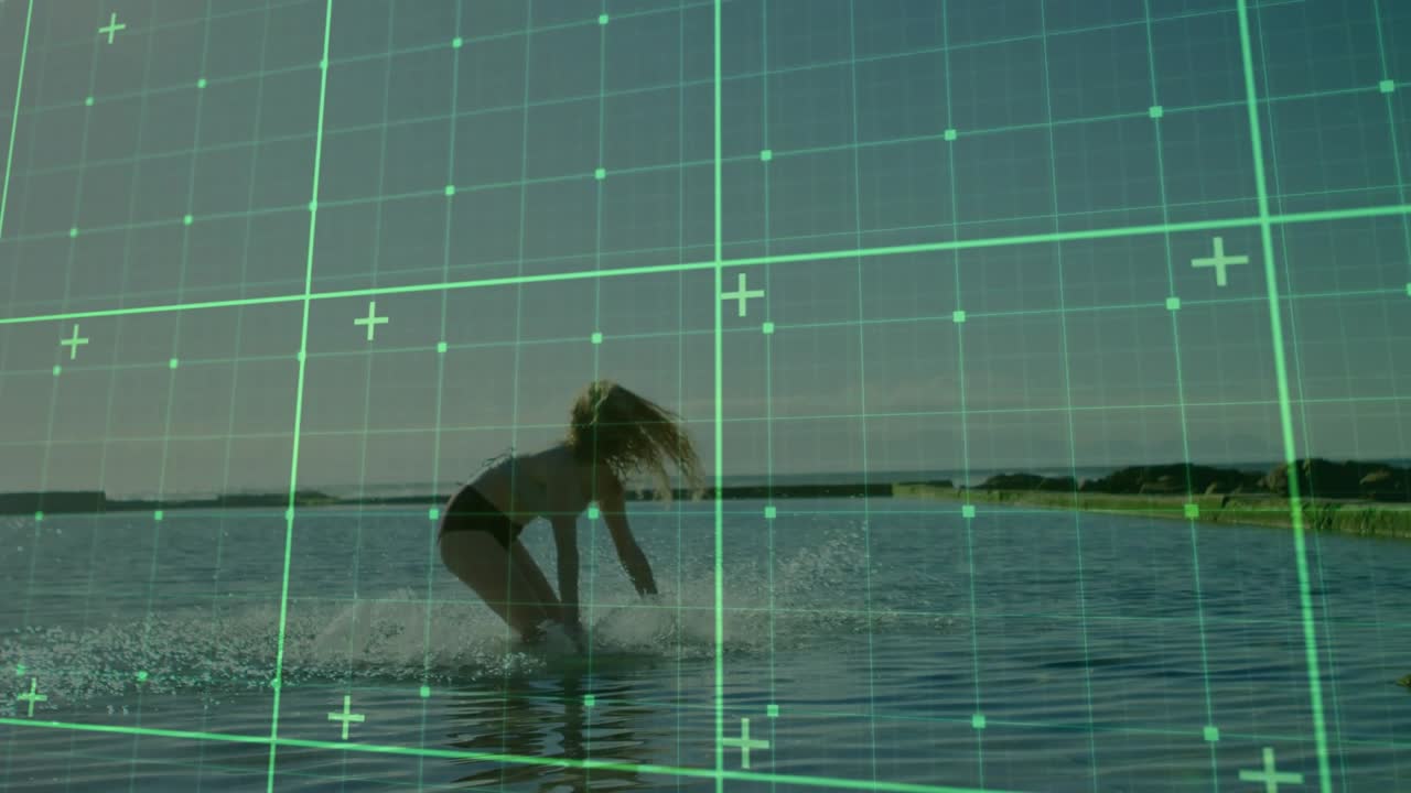 Woman wading into sea water scooping droplets with green grid overlay showing motion in tech demo