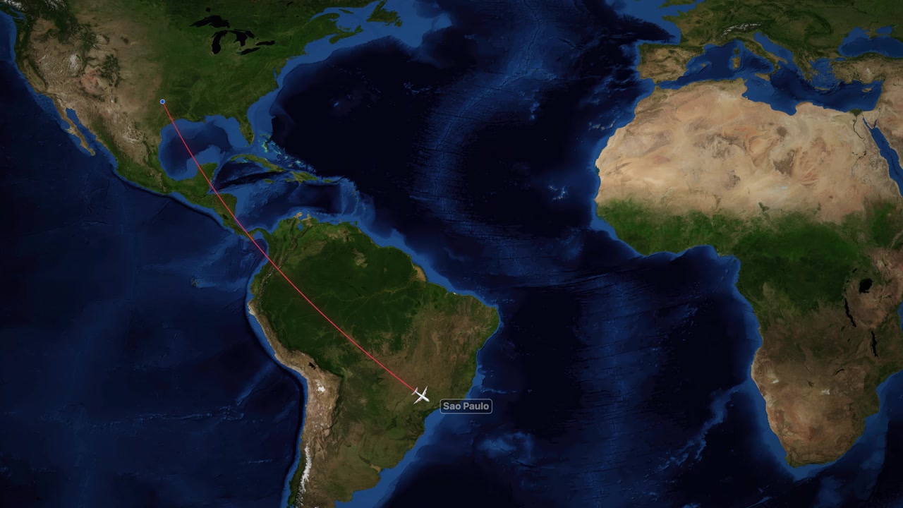 Un'icona di aereo bianca viaggia lungo una linea rossa su una mappa satellitare del mondo.