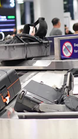 passengers retrieving bags from conveyor belt