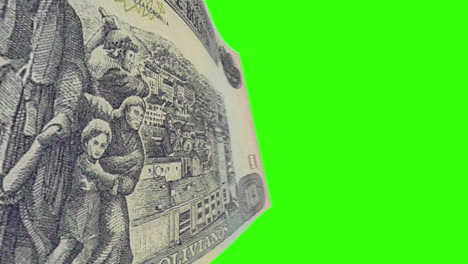 bolivian banknotes featuring historical figures and traditional scenes on green screen