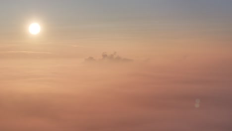 golden sunrise drone view hovering over top of morning fog