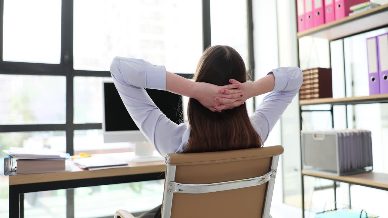 Person relaxing or stretching at an office desk