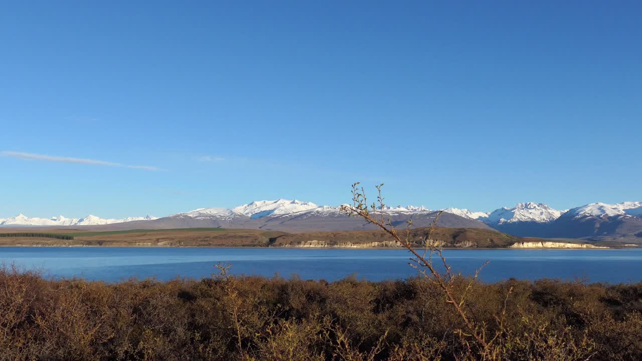 멀리 장엄한 산이 있는 아름다운 짙푸른 고산 호수를 향해 황금시간대, 한겨울 산책