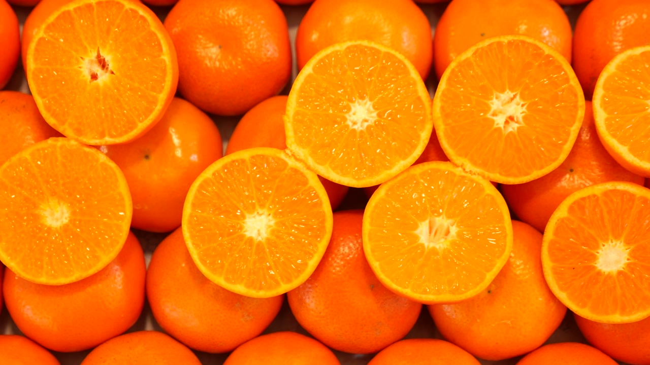 Fresh Whole and Sliced Oranges Zooming Out