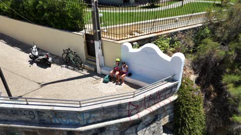 coastal cliffside scene with people and architecture