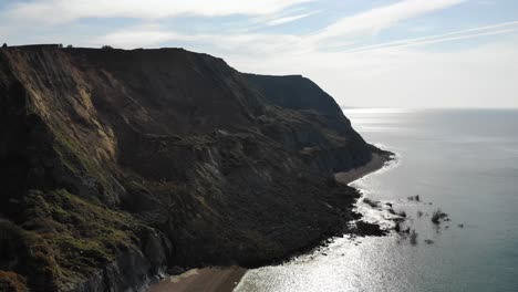 aerial side view of massive jurassic coast cliff fall at seatown in dorset