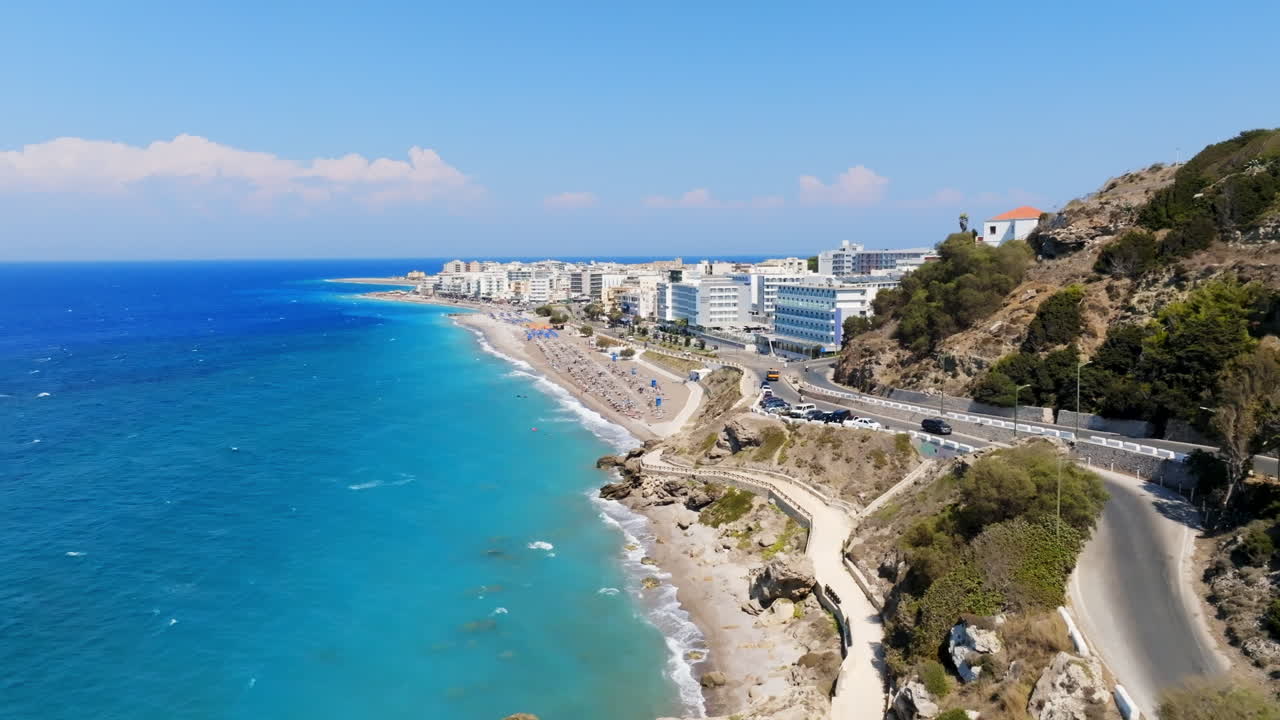 Aerial tracking shot of traffic on the coast of Rhodes city, sunny day in Greece
