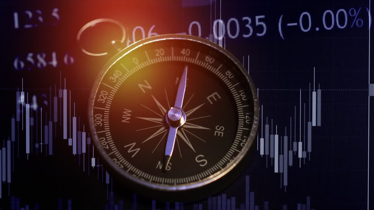 una toma de una brújula con gráfico de comercio