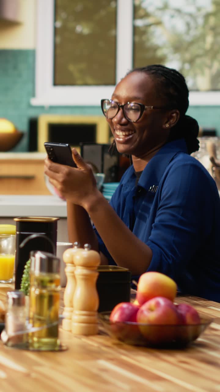 Vertical Video Black people checking something on smartphone enjoying breakfast at home