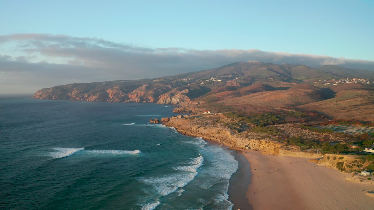 Drone shot of Praia do Guincho at Sunset in Cascais, overlooking the Mountains of Sintra