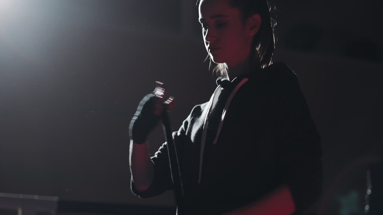 Woman Preparing for Boxing Training by Wrapping Her Hands