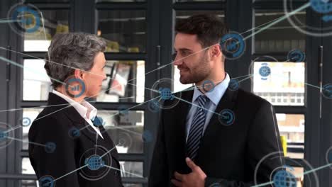 Animation-of-network-of-profiles-over-caucasian-businessman-and-businessman-discussing-at-office