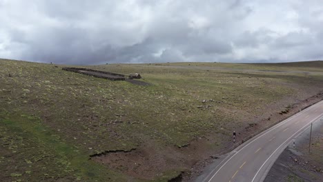 Old-rock-home-and-corral-next-to-highway-Apurimac,-Peru