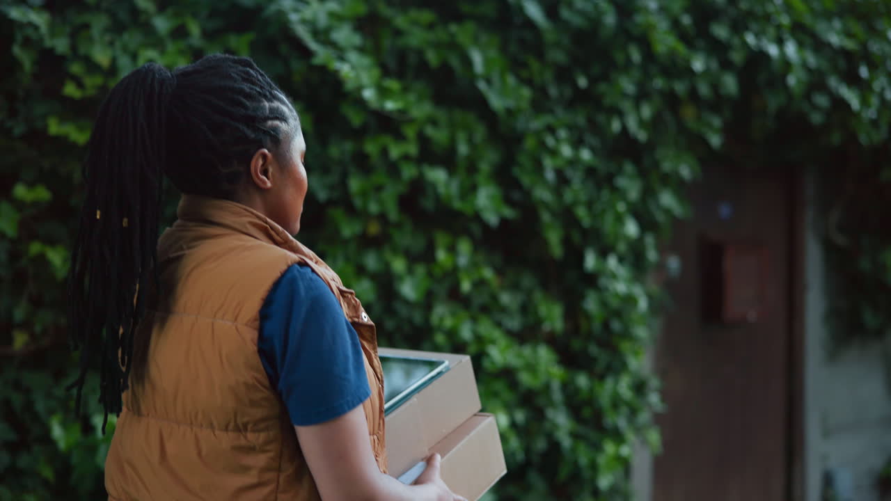 Woman Courier Walking to Deliver Packages to a Home
