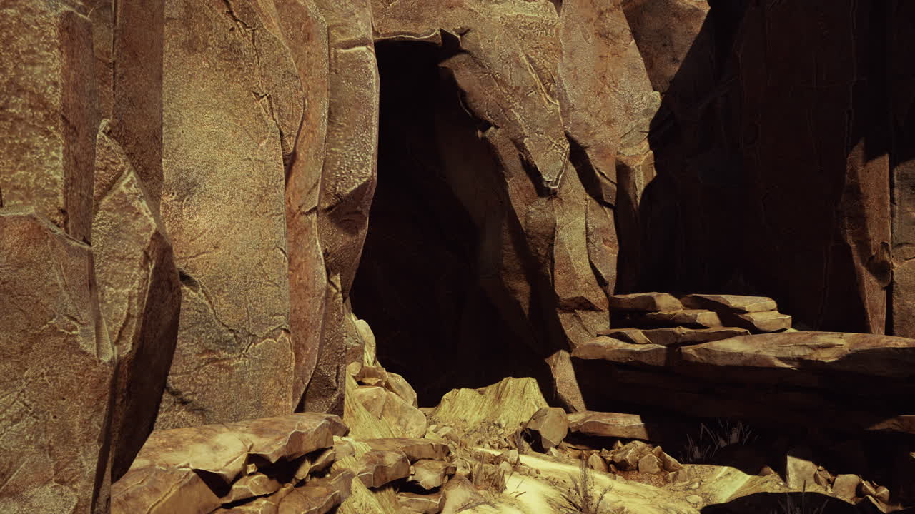 una entrada a una cueva oscura en un paisaje desértico rocoso