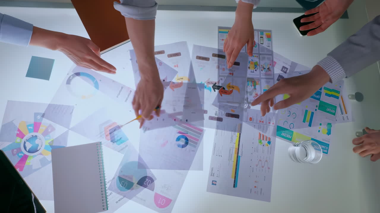 Top view business people working together at office desk, discussions revolving around financial charts, Balance sheet, accounting, taxes, profit to discuss, plan marketing strategy, teamwork concept