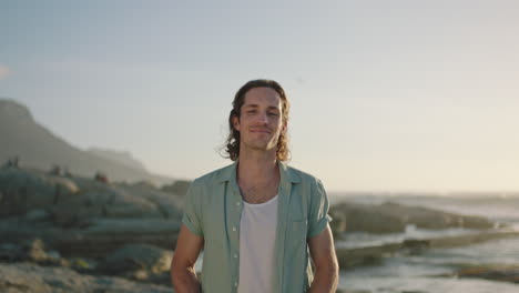 portrait of handsome man standing by sea smiling confident