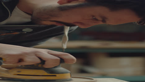 woodworker sanding serving tray