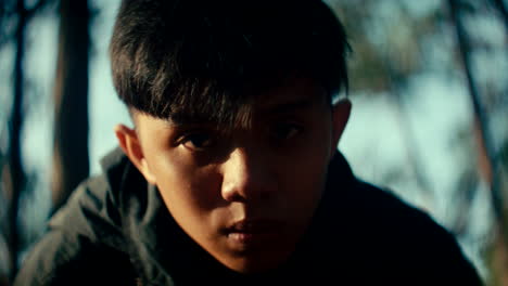 close-up of a boy in a forest