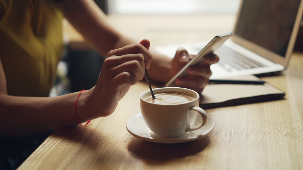 Woman working in a cafe with coffee and laptop