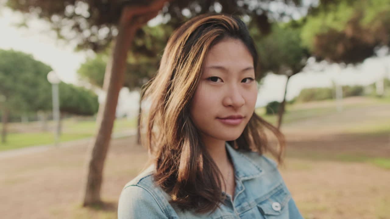 Portrait of an Asian woman in a park