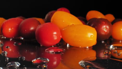 cinematic macro long shot of some red and orange wet cherry tomatoes