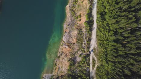 aerial view of a quarry and lake with forest