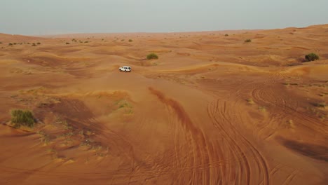 aerial view of a 4x4 vehicle in the desert dunes