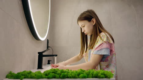girl washing hands in modern bathroom