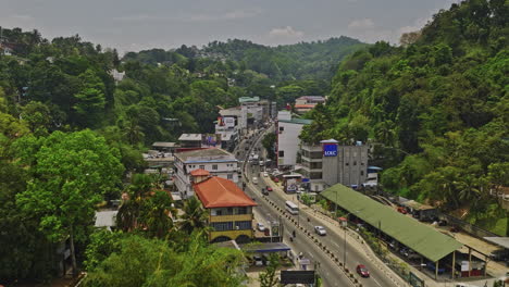 Kandy-Sri-Lanka-Aerial-v6-establishing-drone-fly-along-A9-Katugastota-Rd-across-Nittawela-suburb-capturing-local-activities-and-hillside-lush-greenery---Shot-with-Mavic-3-Cine---April-2023