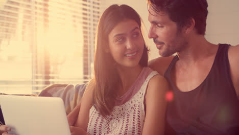 Couple-using-laptop-in-living-room-at-home-4k