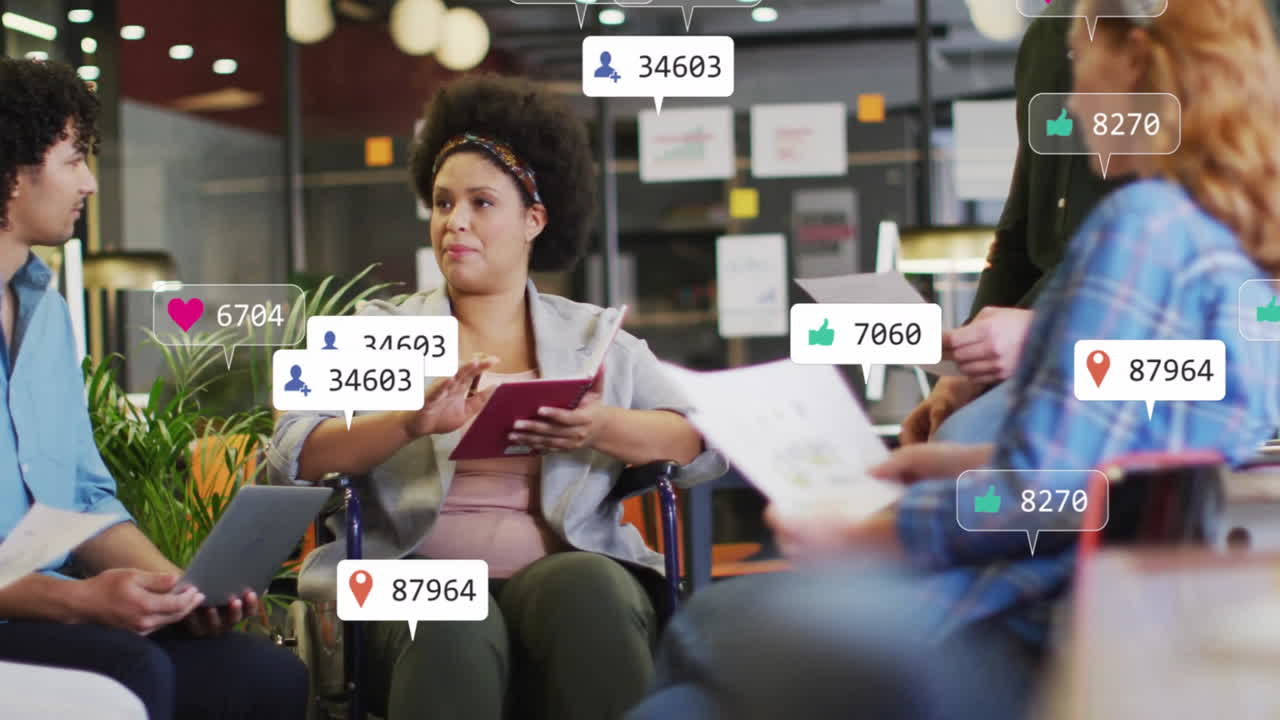 Wheelchair user leading business meeting, sharing tablet and red notebook with floating notes icons