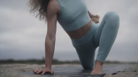 complicated yogi stretches outdoors for flexibility