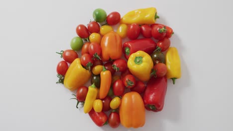 Video-of-fresh-peppers-and-tomatoes-on-white-background