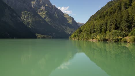 peaceful serene lake surrounded by mountains crystal clear water reflects the surrounding natural beauty creating a mesmerizing view mountains form a backdrop and invite visitors to explore the area