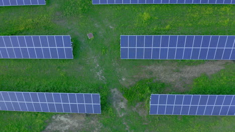 Luftaufnahmen:-Von-Oben-Nach-Unten-Zeigen-Sich-Sonnenkollektoren-Auf-Einem-Grünen-Feld
