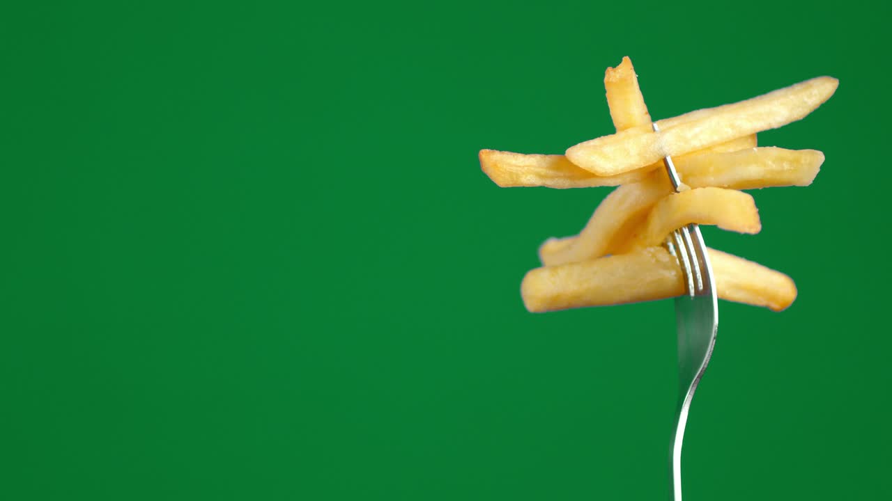 French fries on a fork slowly rotates.