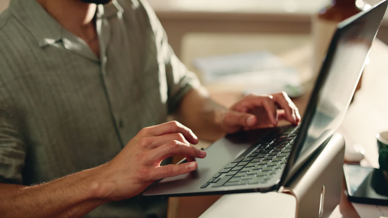 Close Up of Man's Hands Typing on Laptop Keyboard