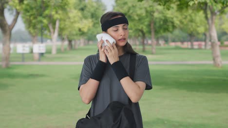 indian girl taking out towel from duffel bag