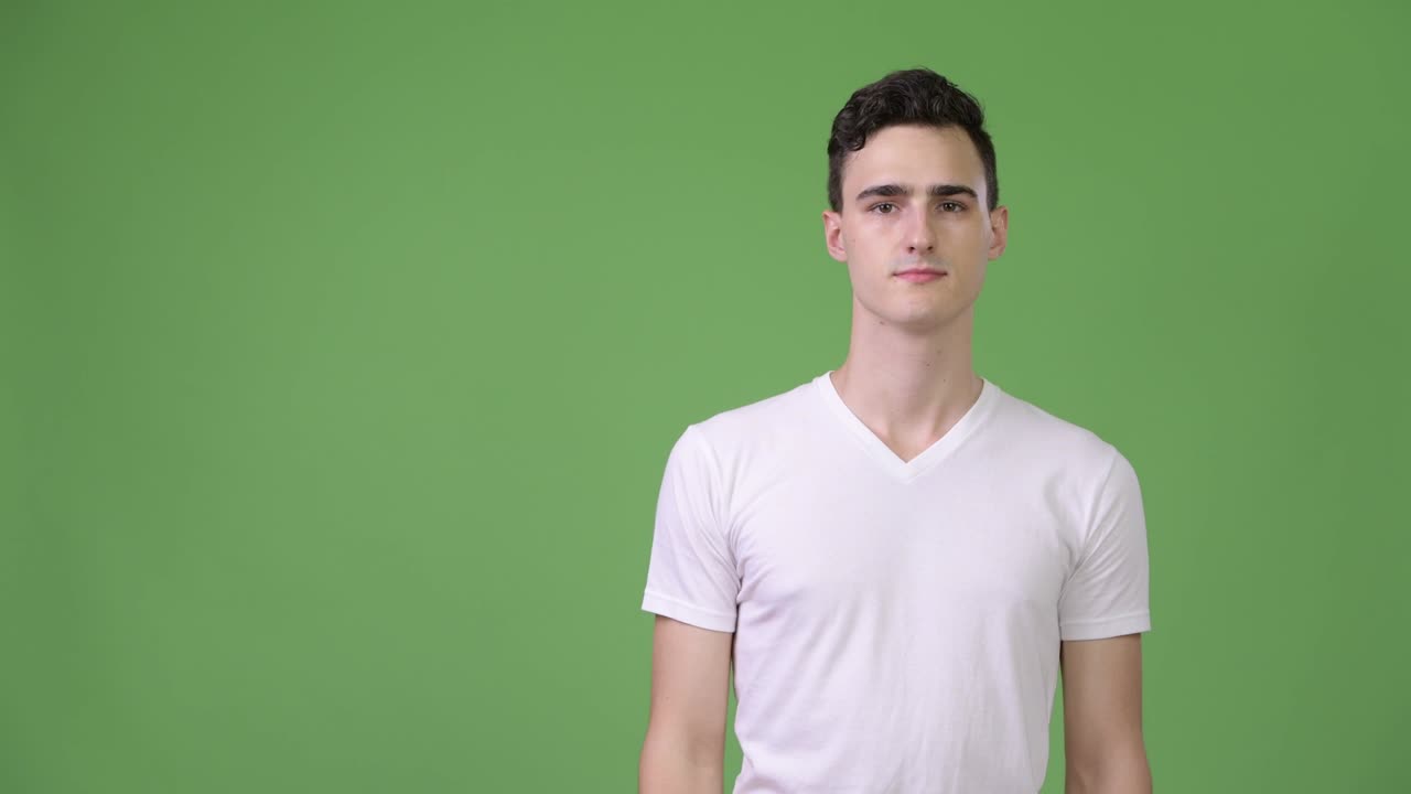 Young handsome man thinking while pointing finger up