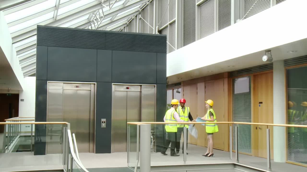 architetti con piani che parlano di una costruzione di un edificio