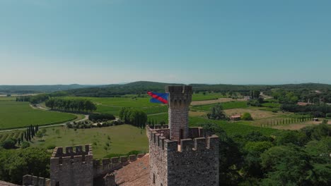 flag over château de pouzilhac ramparts - aerial wide view