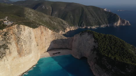 Stunning-aerial-footage-of-Shipwreck-Beach-at-Navagio-Beach,-showcasing-the-breathtaking-cliffs-and-azure-waters